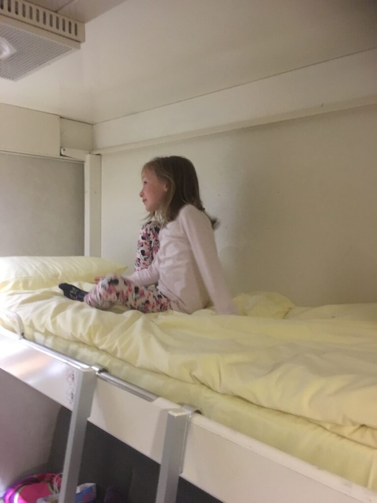 Child on the top bunk in a Brittany Ferries Ferry cabin